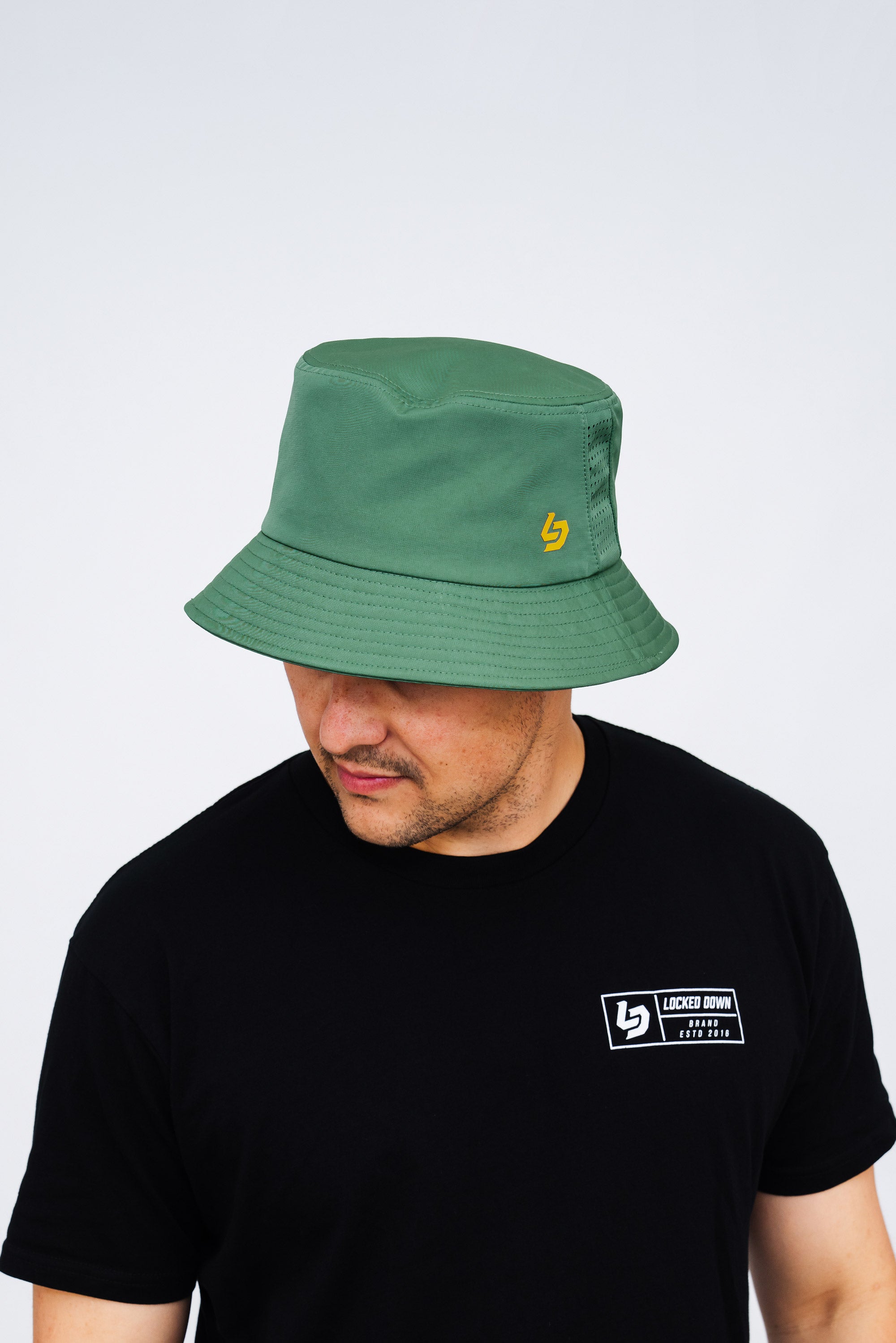 Locked Down Brands Premium Water Resistant Stamp Bucket Hat With Laser Holes - Green/Gold